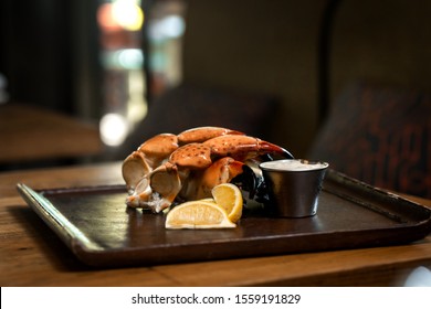 Fresh Stone Crab Claws with lemon and lime, sauce in a dish in a restaurant
