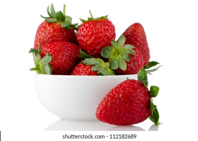 Fresh Strawberries In Bowl On White Reflective Background.