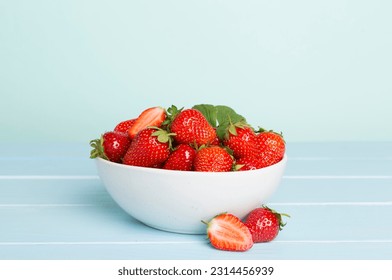 Fresh strawberries in bowl on wooden table - Powered by Shutterstock