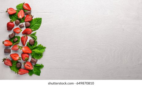 Fresh Strawberries And Chocolate. Healthy Food. On Wooden Background. Top View. Free Space.