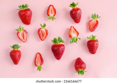 Fresh strawberries creative flat lay close-up on a pink background. Fresh berries, summer harvest, fruits, healthy food, diet concept. . High quality photo