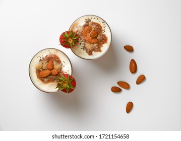 Fresh Strawberries With Soy Yoghurt, Oat Flakes, Almonds, Red Fruit Jam, Coconut Flour And Chia Seeds.