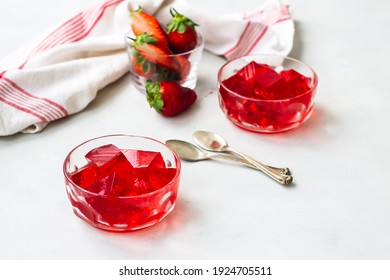 fresh strawberries and a strawberry jelly dessert, jello cubes