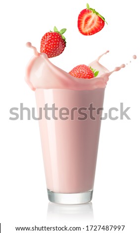 fresh strawberry berries falling in glass with pink milkshake isolated on white background