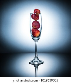 Fresh Strawberry In The Champaign Glass,stand On Reflective Floor.