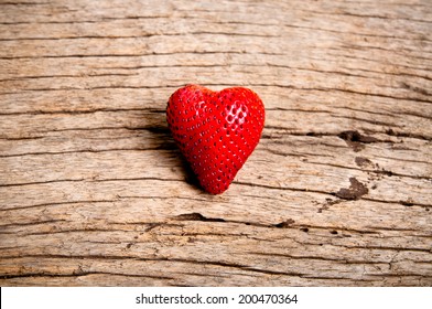 Fresh Strawberry in Heart Shape on Wood Table Background, Rustic Still Life Style. / Concept and idea of Food Decoration and Love Romantic.