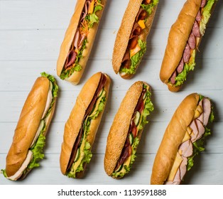 Fresh Sub Sandwich On White And Wheat Hoagies.