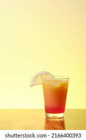 Fresh Summer Alcohol Free Virgin Sex On Beach Drink With Orange And Red Fruit Juice In Glass With Ice And Slice Of Lemon