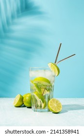 Fresh Summer Caipirinha Cocktail On Blue Background With Green Fruit Lime On Table