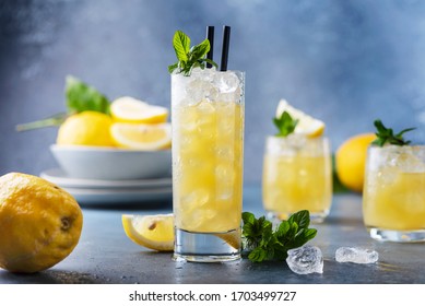 Fresh summer cocktail with lemons, mint and ice, selective focus image