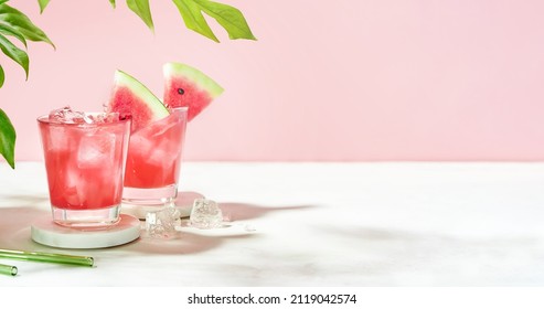 Fresh summer cocktail watermelon juice with ice in a two glass and glass straw on pink background. Layout for wide banner with space for text. - Shutterstock ID 2119042574