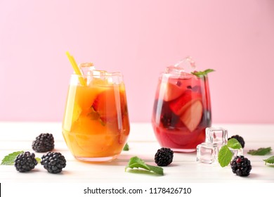 Fresh summer cocktails in glasses on white wooden table