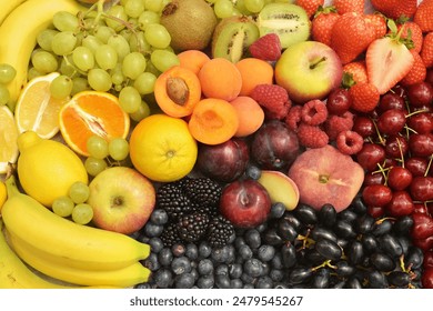 Fresh summer different berries, fruits colourful background. Banana, grapes, cherries, lemon, orange, apricots, apple, blackberries, raspberries, blueberries, strawberries, kiwi, plum. Healthy food. 