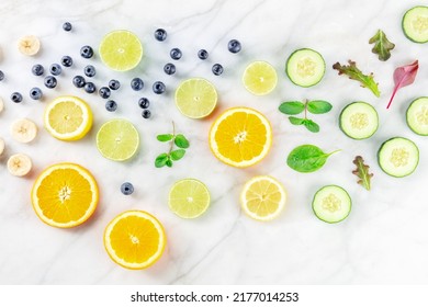 Fresh Summer Food. Citrus Fruit And Vegetable Slices, Overhead Flat Lay Shot On A White Marble Kitchen Table. Healthy Plant-based Diet