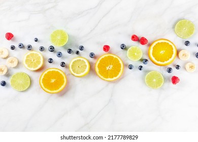 Fresh Summer Food. Citrus Fruit Slices, Overhead Flat Lay Shot On A White Marble Kitchen Table. Healthy Vegan Diet With Copy Space