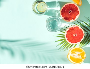 fresh summer fruit and water galss on blue background flat lay