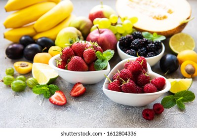 Fresh Summer Fruits And Berries On A Concrete Background