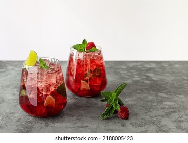 Fresh Summer Lemonade With Raspberry, Lime, Soda Water, And Ice In Glasses. Cold Refreshing Drink, Cocktail Or Mocktail.