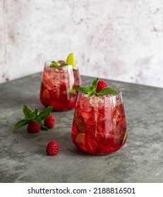 Fresh Summer Lemonade With Raspberry, Lime, Soda Water, And Ice In Glasses. Cold Refreshing Drink, Cocktail Or Mocktail.