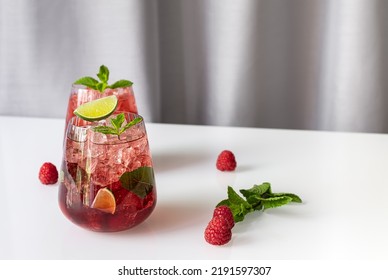 Fresh Summer Lemonade With Raspberry, Lime, Soda Water, And Ice In Glasses. Cold Refreshing Drink, Cocktail Or Mocktail.