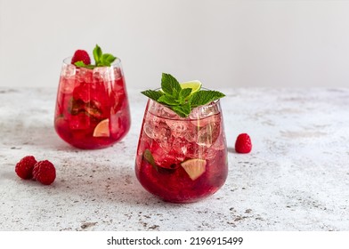 Fresh Summer Lemonade With Raspberry, Lime, Soda Water, And Ice In Glasses. Cold Refreshing Drink, Cocktail Or Mocktail.