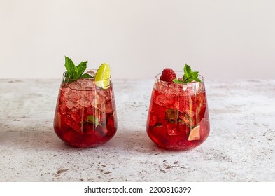 Fresh Summer Lemonade With Raspberry, Lime, Soda Water, And Ice In Glasses. Cold Refreshing Drink, Cocktail Or Mocktail.