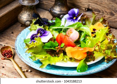 Fresh summer salad with edible flowers and herbs.Healthy food - Shutterstock ID 1043188213