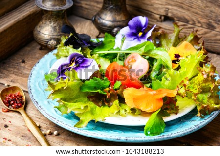 Fresh summer salad with edible flowers and herbs.Healthy food