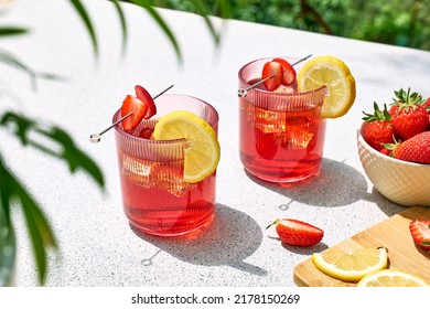 Fresh summer strawberry cocktail or mocktail on the table in the garden. Sparkling pink strawberry lemonade. - Powered by Shutterstock