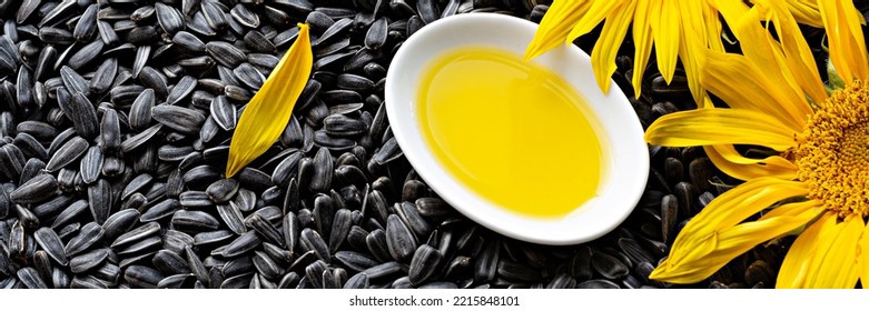 Fresh Sunflower Flower On A Background Of Black Seeds With A Bowl Of Sunflower Oil, Vegetable Oil By Cold Pressing. The Concept Of Vegetable Fats.