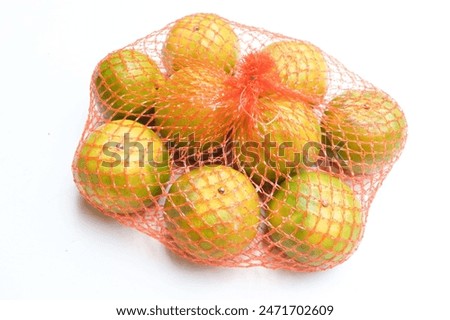 fresh sweet appetizing oranges fruit in plastic mesh sack  and yellow discount sign isolate on a white backdrop