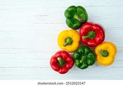 Fresh sweet bell pepper ( paprika ) photography red , green and yellow . Colorful vegetable . Top view on rustic background - Powered by Shutterstock