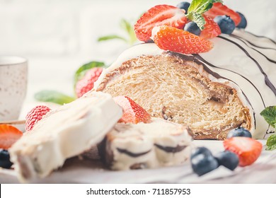 Fresh sweet braided bread in white chocolate with fresh berries