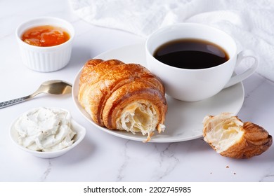 Fresh sweet croissants with cottage cheese and apricot jam for breakfast. Continental breakfast on a white table