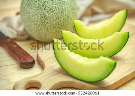 Fresh sweet green melon on the wooden table