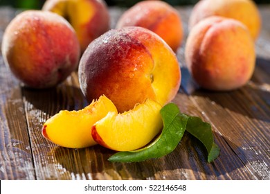 Fresh sweet group of sliced peaches on wooden background in the garden - Powered by Shutterstock