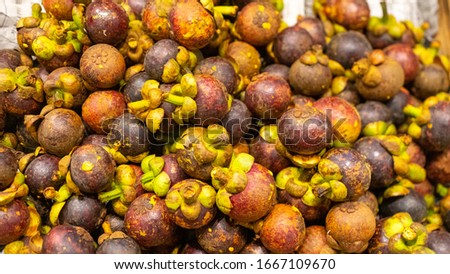 Fresh sweet mangustines on night market