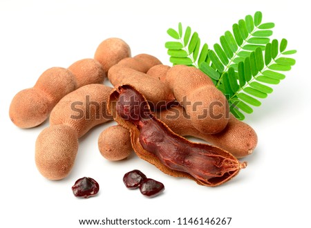 fresh tamarind fruits and leaves isolated on white background