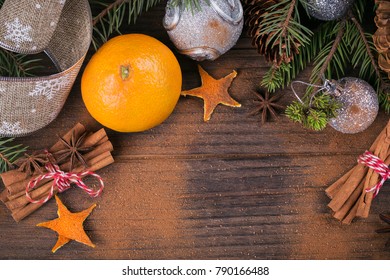 Fresh Tangerines with spices and Christmas decor with Xmas tree on dark old wooden table. Rustic style. Winter holiday concept. Top view with space for text - Shutterstock ID 790166488