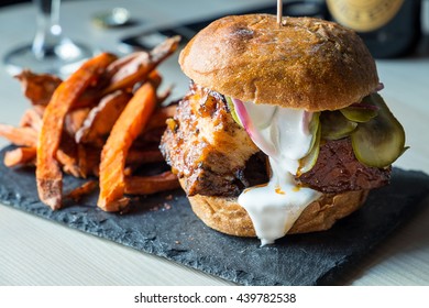 Fresh Tasty Bacon Big Burger with Fried Sweet Potatoes and White Sauce, Close-up - Powered by Shutterstock