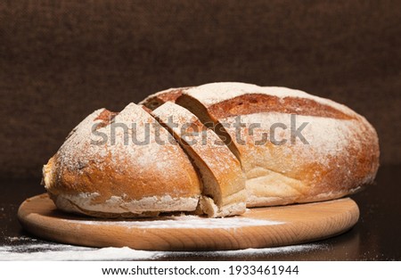 Fresh and tasty bread on a wooden board. Bakery products.