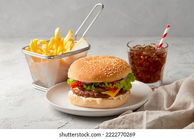 Fresh tasty burger, french fries and soft drink on dark background - Powered by Shutterstock