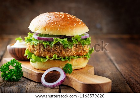 Fresh tasty chicken burger on wood table.