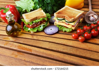 Fresh And Tasty Sandwich On Wooden Cutting Board