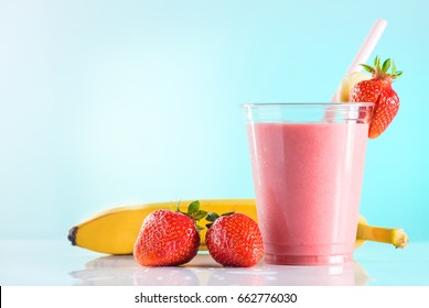 Fresh Tasty Strawberry Smoothie In Glass Cup With Drinking Straw On Azure Background. Strawberries And Banana Near The High Ball