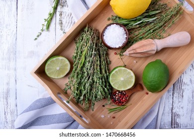 Fresh Thyme, Pepper Peas, Sea Salt, Lemon And Lime On Wooden Tray. Ingredients For Making Marinade