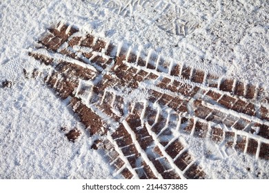 Fresh Tire Marks On Soft Snow On A City Sidewalk.