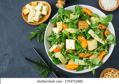 Fresh tofu salad with sesame seeds, corn salad, apricote and bamboo in the bowl - Shutterstock ID 1754712485
