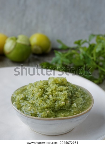 Fresh tomatillo green salsa (salsa verde
cruda) in a bowl. Typical Mexican
cuisine.
