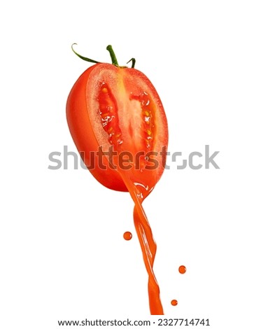 Fresh tomato juice pouring from ripe red halved sliced vegetable with green stem and leaves isolated on white background used as ingredient for salads, sauce, ketchup and drinks full of vitamins